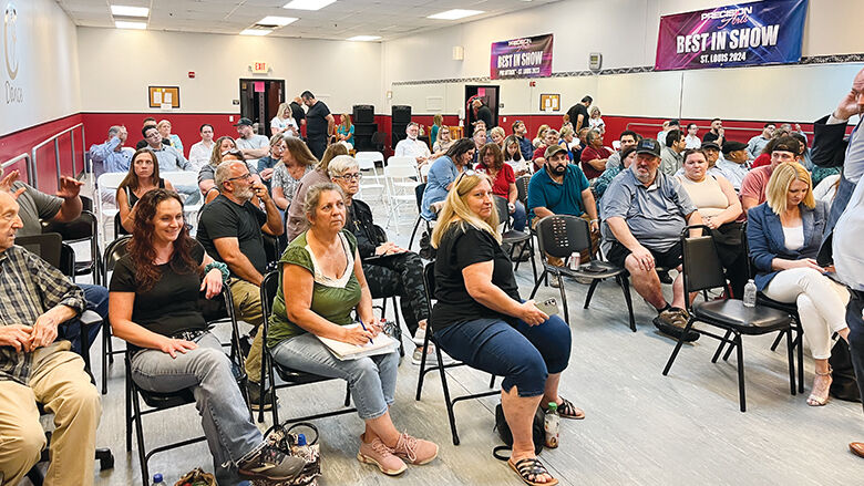 Business owners and community members gather at a meeting held to discuss the proposed Arnold Parkway.